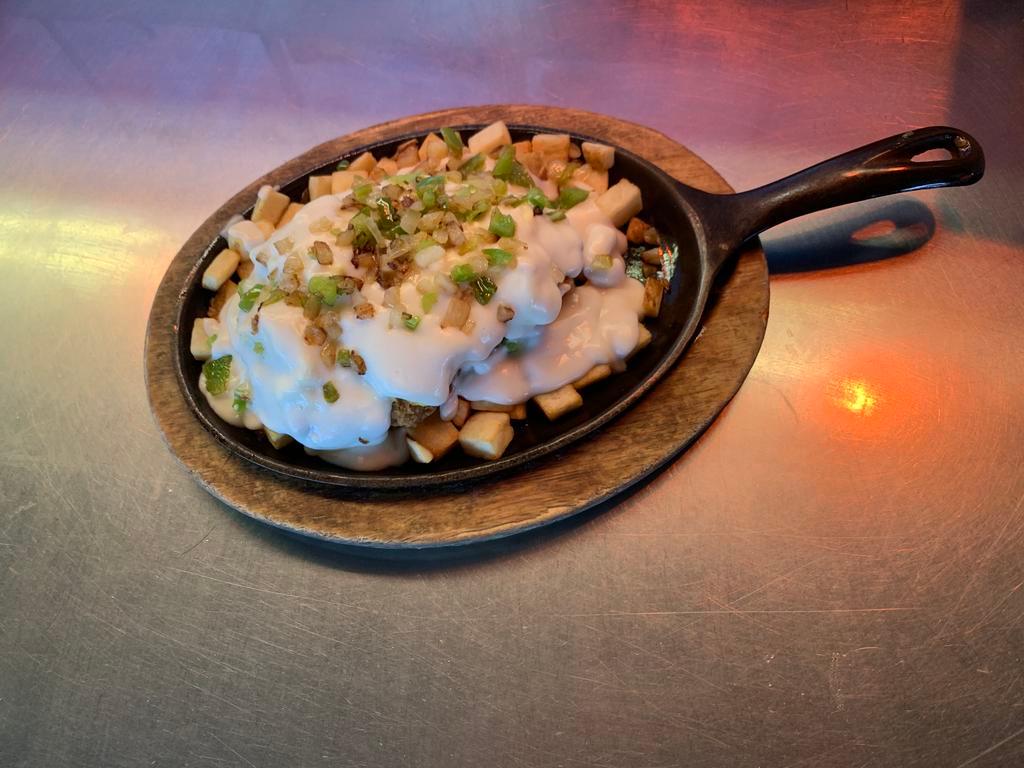 Country Fried Steak Skillet · Country fried steak served with 2 eggs, onions, bell peppers, white gravy and country potatoes.