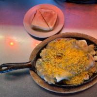 Burrito Skillet · 2 eggs, 2 beef burritos, refried beans, green chili, shredded cheese and country potatoes.