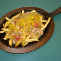 Chili Fries · Fries covered in chili and cheese served on a skillet.