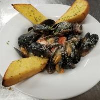 Mussels Scampi · Sauteed in garlic butter with cherry tomatoes and white wine.