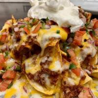 Classic Nachos · Corn tortilla chips, shredded cheddar and Monterrey Jack, chili, jalapenos, diced tomatoes, ...