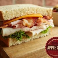 Cafe Club · Cured ham, oven-roasted turkey breast, crispy bacon, lettuce, and cheddar cheese with our si...
