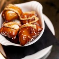 Bavarian Pretzel Bites · served with a signature mustard dipping sauce. 