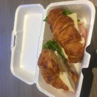 Whole Croissant Sandwich · Turkey, ham, lettuce, tomato, mayo and Swiss.
