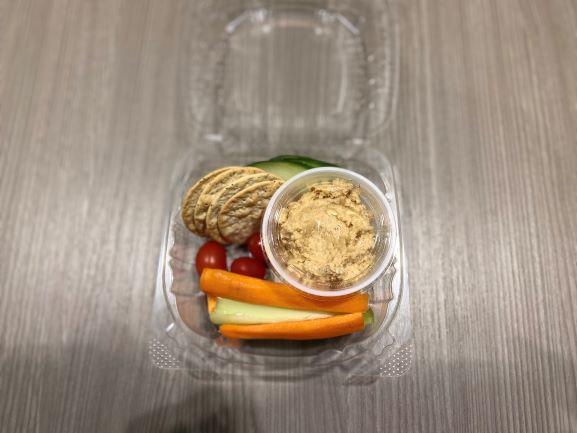 Veggie Humus Cup · Homemade humus, celery, carrots, cucumber, tomato grapes and crackers.