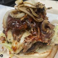 Cowboy Burger · Brisket patty, Munster cheese, smoked pulled pork, crispy onions, shredded lettuce, and BBQ ...