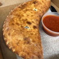 Veggie Calzone · Onions, mushrooms, peppers, spinach, tomatoes, and olives.
