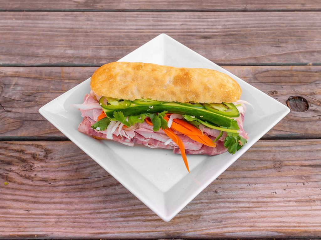 Z7T. Classic Banh Mi · Country ham, pate, demi baguette, pickled carrots and daikon, cilantro, scallions, cucumbers, jalapeno and garlic aioli.