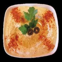 Hummus · Crushed garbanzo beans with sesame oil (tahini), lemon juice and garlic. Served with 2 piece...