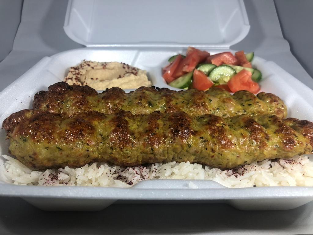 Chicken Lula Kabob Plate · Two skewers of ground chicken marinated with our mix of spices served over rice, with salad, hummus, pita bread, BBQ tomato, and jalapeno.
