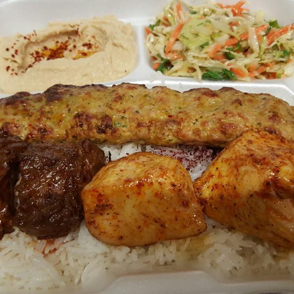Lula Kabob Combo · 2 pieces each of beef shish & chicken shish, with  1 skewer of chicken lula, served on a bed of rice, sides of salad, hummus, pita bread, BBQ tomato, and jalapeno.