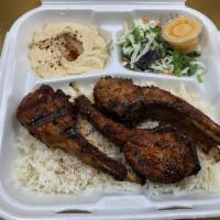 GRASS-FED LAMB CHOPS Plate · Organic, grass-fed lamb chops marinated and grilled, served with rice, salad, hummus, and pi...