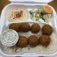 Falafel Plate · Falafel balls mixed with herbs & spices served on a bed of rice, sides of salad and hummus, ...