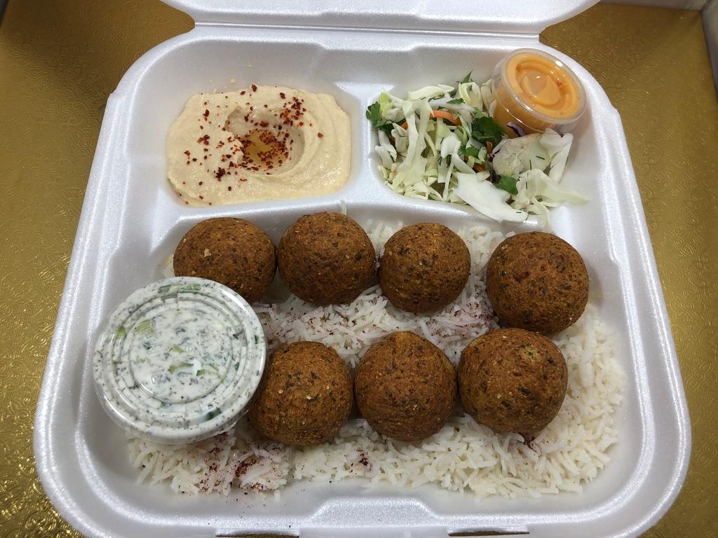 Falafel Plate · Falafel balls mixed with herbs & spices served on a bed of rice, sides of salad and hummus, topped with pita bread and side of tzatziki sauce.