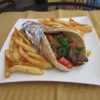 Lamb and Beef Gyro Pita Wrap · Strips of lamb and beef gyro wrapped and topped with onions, cilantro, tomatoes, and tzatzik...
