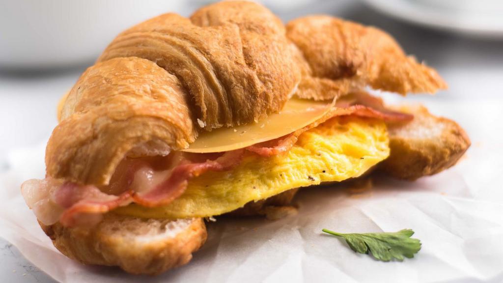 Bacon, Egg & Cheese on Croissant · Customer's choice of eggs, melted cheese and crispy bacon strips inside warm and buttery croissant.