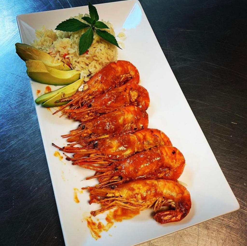 Langostinos · Whole prawns sauteed in red sauce served with white rice and fresh salad.