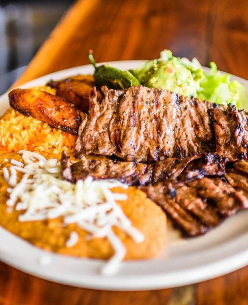Carne Asada · Grilled skirt steak, served with rice, beans, flour tortillas, lettuce, pico de gallo and guacamole.