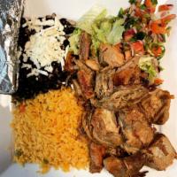 Carnitas · Slow-cooked pork tips, served with rice and beans, side salad topped with green peppers, oni...