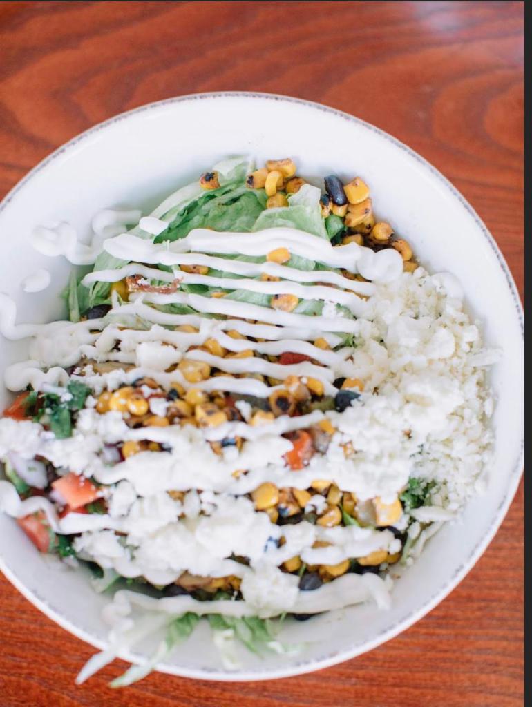 Burrito Bowl · White rice, lettuce, south western style corn mix, sour cream, queso fresco and your choice of meat.