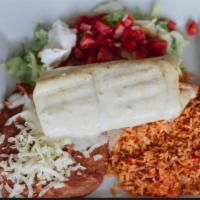 Chimichanga · Beef or chicken. Rice and beans, toppings lettuce, sour cream, tomato, covered with queso.