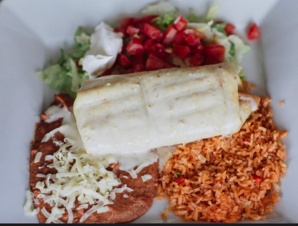 Chimichanga · Beef or chicken. Rice and beans, toppings lettuce, sour cream, tomato, covered with queso.
