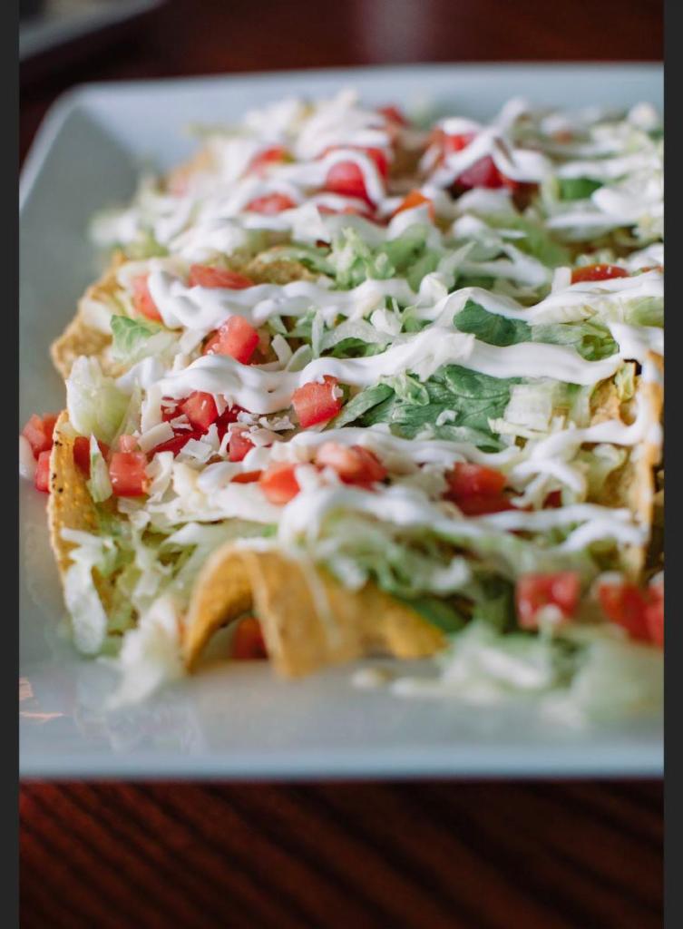 Nachos Habanero · Steak, grilled chicken or chorizo. Toppings lettuce, sour cream and guacamole.