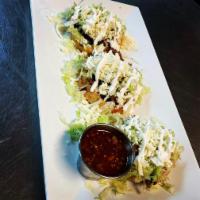 Sopes · 3 pieces, corn dough dip fried, chicken, beef. Topped with lettuce sour cream and queso fres...