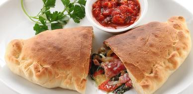 Mediterranean Calzone · Served with spinach, feta cheese, black olives and mozzarella.