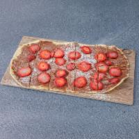 Strawberry Nutella Pizza · Fresh sliced strawberries, Nutella spread and powdered sugar on a crispy grilled pizza shell.