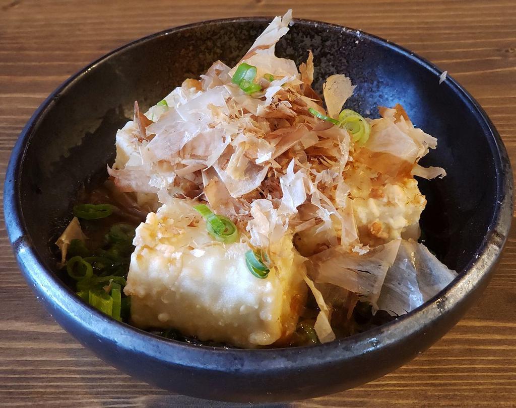 Agedashi Tofu · Lightly battered fried Japanese tofu in Tsuyu broth, grated daikon. Topped with bonito flake and scallions.