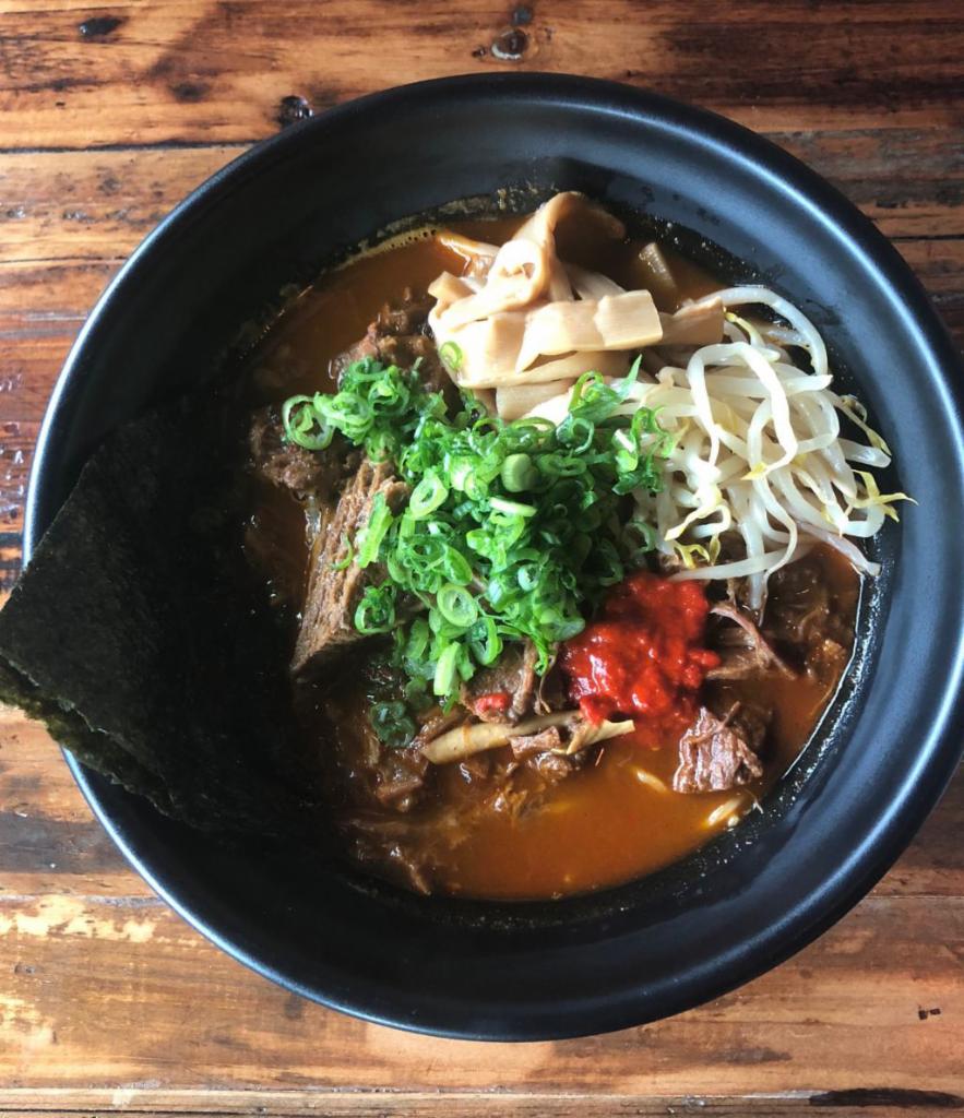 Spicy Miso Beef Stew · Slow cooked beef frank with spicy miso, Japanese bamboo, sesame seeds, scallion, beansprouts. Topped with spicy chili vinegar.