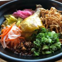 Kao Soi · Northern style curry noodle dish with chicken drumstick, steamed ramen noodle, pickled green...