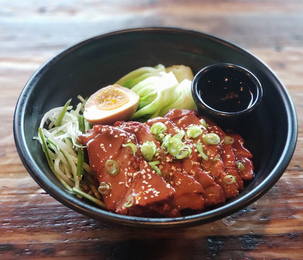 Roasted Pork Rice Bowl · Roasted pork, marinated soft boil egg, bok choy, cucumber, sesame seeds and scallion. Served with hot sweet soy sauce.