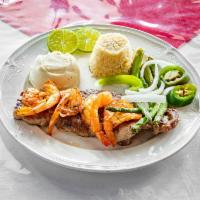 Rib Steak La Costa · Ribeye steak with jumbo shrimp. Served with mashed potatoes, rice and asparagus.