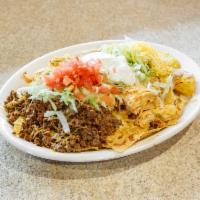 Nachos Supremos · Our cheese nachos covered with beef, chopped chicken, re-fried beans, shredded lettuce, toma...