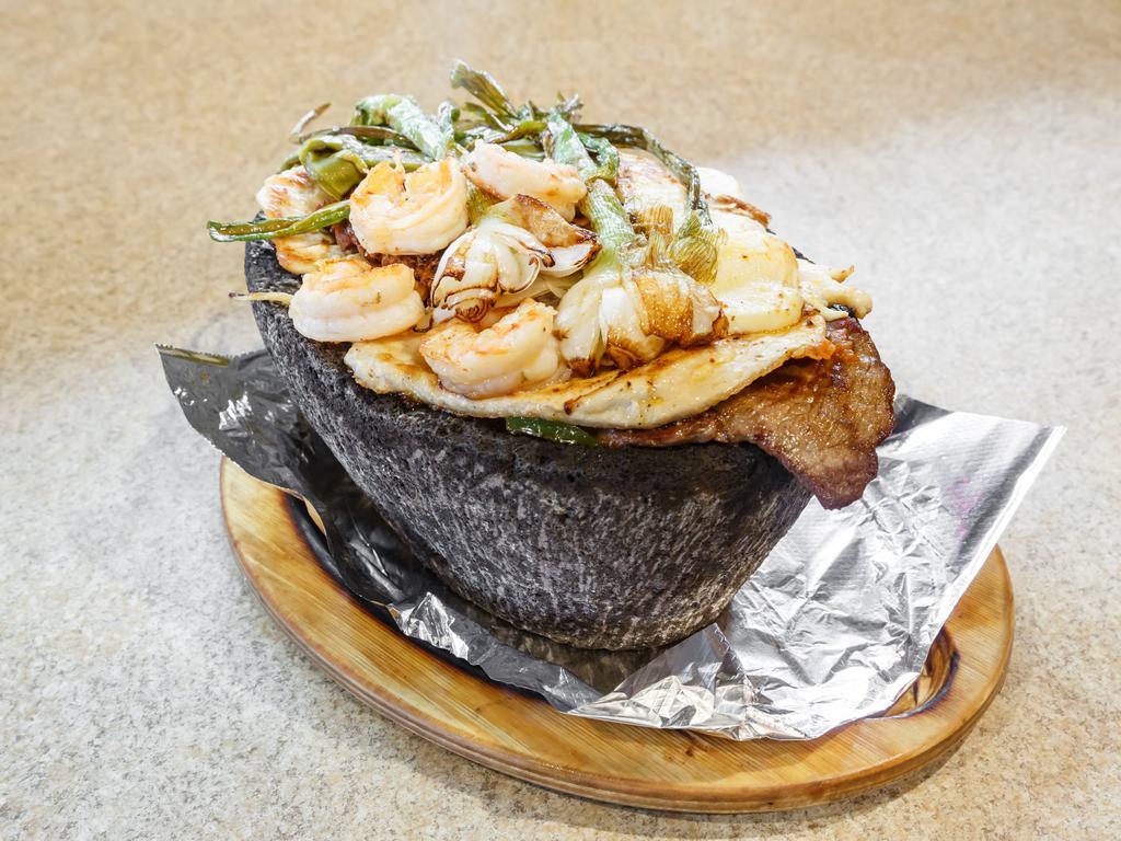 Molcajete Special Fajita · Steak, grilled chicken, shrimp and chorizo, sauteed with onions, bell peppers and tomatoes, topped with tomatillo hot sauce, garnished with Mexican onions, cactus leaf and slice of queso fresco, served with rice, beans and tortillas.