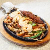 Fajitas Jalisco · A sizzling platter of tender marinated beef chicken, shrimp and chorizo grilled using our sp...