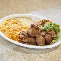 Carnitas · Pork tips served with Mexican rice, re-fried beans, salad and tortillas.