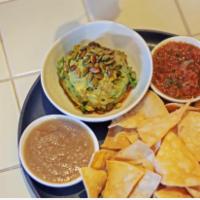 Chips Guacamole and Salsas · Our chips and guacamole served with ranchera and pina salsa.
