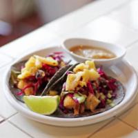 2 Pescado Tacos · Hand-pressed corn tortillas, 3 sisters' grits, Alaskan cod, pickled cabbage slaw, cilantro c...