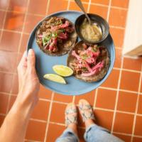 2 Ranchera Tacos · Hand-pressed corn tortillas, steak, habanero pickled red onions, cilantro and pina salsa on ...