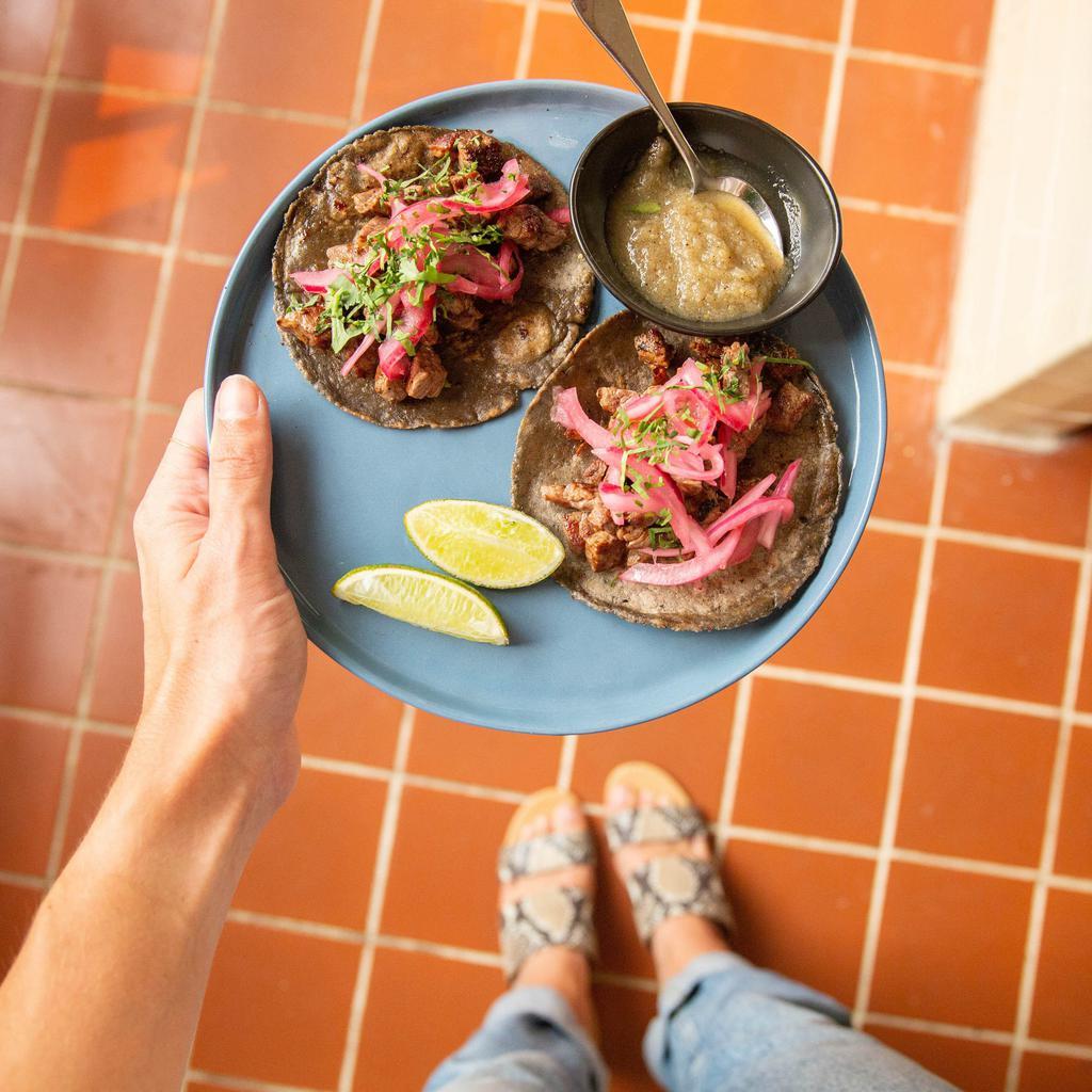 2 Ranchera Tacos · Hand-pressed corn tortillas, steak, habanero pickled red onions, cilantro and pina salsa on the side.