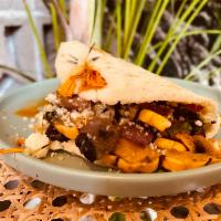 Arepa Vegetariana · Made with maize and plantain. Served with black beans, roasted red onions, roasted delicata ...