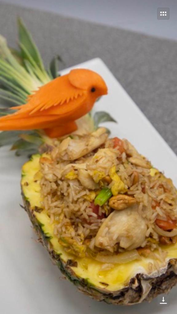 102. Pineapple Fried Rice · Fried rice sauteed with pineapple, cashew nuts, onion, scallion and egg with brown sauce.