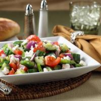 Greek Salad · Crisp romaine lettuce, fresh tomatoes, sliced onions, green peppers and cucumbers topped wit...