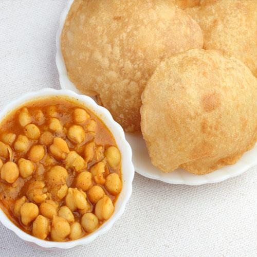 Poor with Channa · Channa masala or Chole is a delicious Indian dish made by chickpeas in a spicy onion & tomato gravy with handful of Indian spices topped with fresh cilantro served with Poori