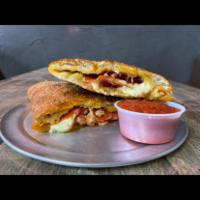 Pizzadilla · A Calzone Made with Mozzarella, and One-Topping of Choice. Served with Marinara Dipping Sauc...