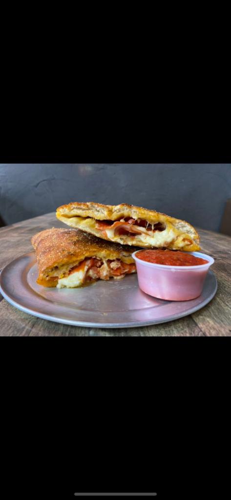 Pizzadilla · A Calzone Made with Mozzarella, and One-Topping of Choice. Served with Marinara Dipping Sauce. 