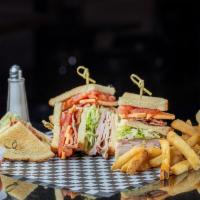 Club Sandwich · Ham, turkey, bacon, American cheese piled high on potato bread with lettuce, tomato, and mayo.